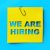 “We are hiring” yellow banner on blue textured background