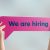Hand holding speech bubble with we are hiring word